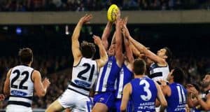 Australian Rules Football players battling for possession 
